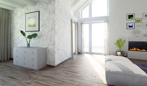 Modernes, helles Wohnzimmer mit Holzboden, Kamin, weißen Möbeln und grünen Pflanzen. Wohnambiente der KWG Gröditz.
